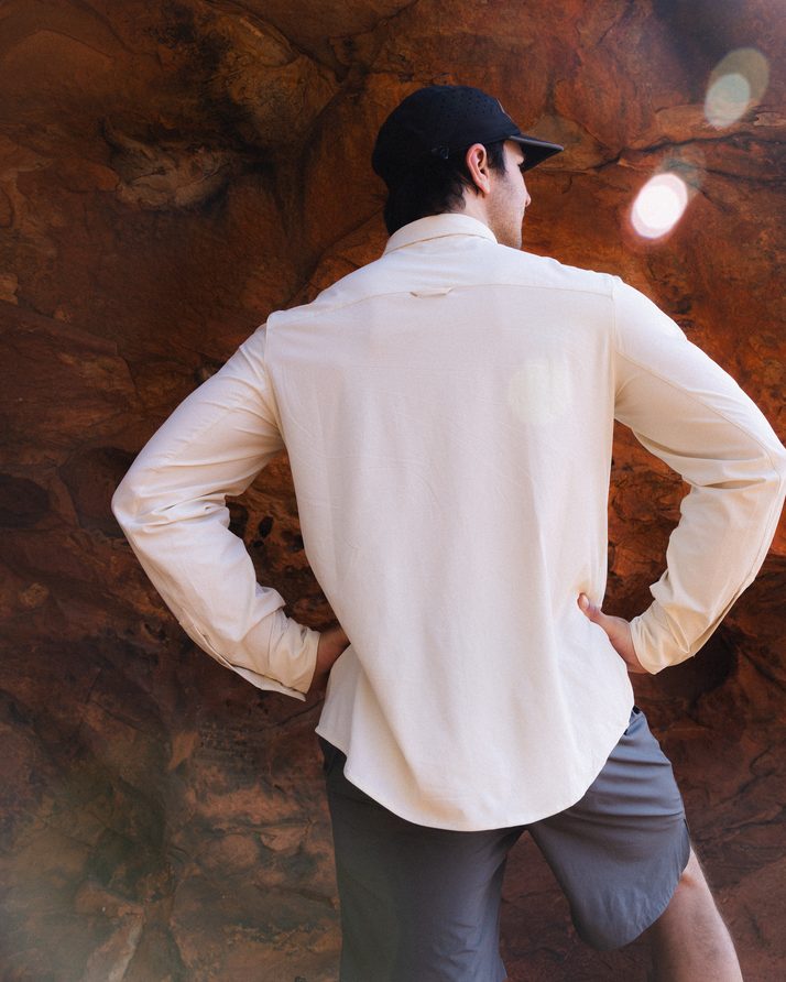Back of the Beachwood Daylight™ Technical Long Sleeve Shirt, hands on hips in a sandstone gorge
