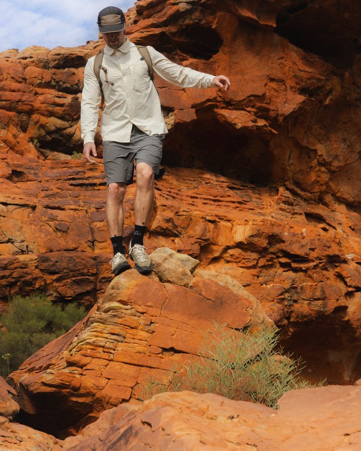 Hiker stepping down red sandstone at Kings Canyon in Daylight™ Shorts in Ash