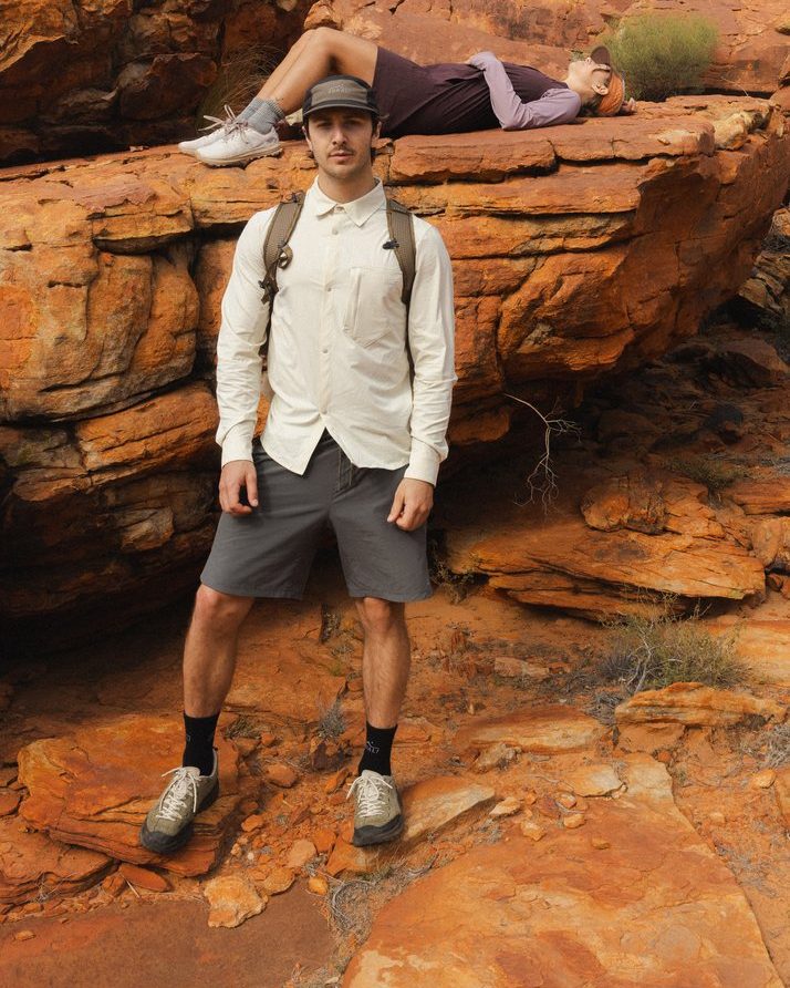 Hiker with a pack on red rock in Daylight™ Shorts in Ash