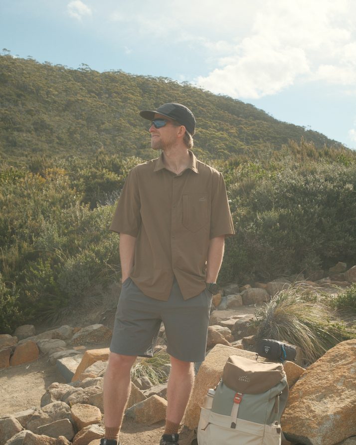 Hiker on a rocky Three Capes coastal track in the Teak Daylight™ Short Sleeve Shirt