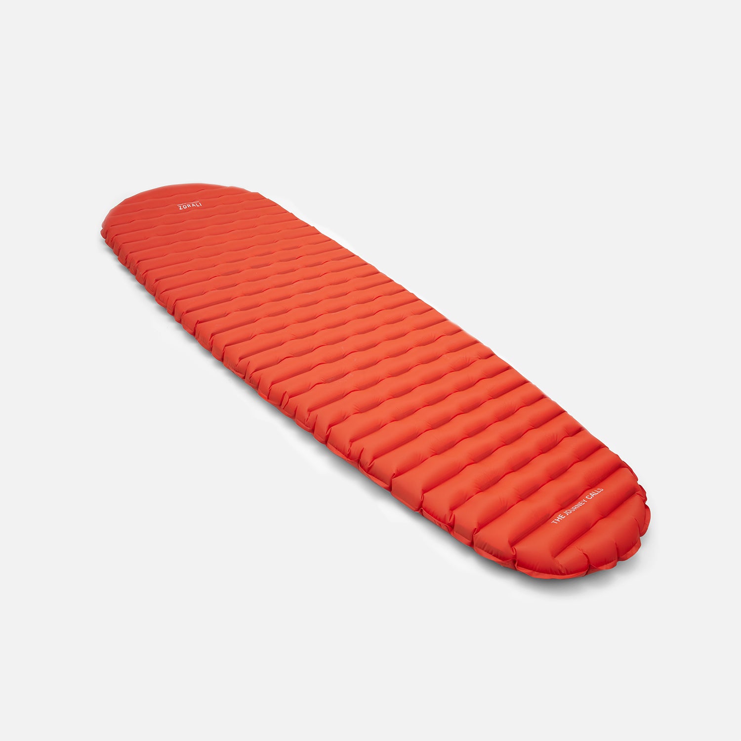 Red inflatable sleeping pad on a light gray background