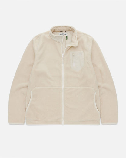 Cream sherpa fleece jacket laid flat, showing the zip front, chest pocket, and Cosy Camp Fleece woven label at the collar.
