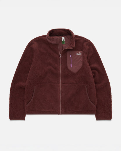 Maroon sherpa fleece jacket laid flat, showing the zip front, chest pocket with purple zipper pull, and Cosy Camp Fleece woven label.