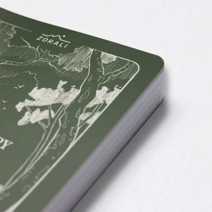 Green notebook with white map design on a light gray background