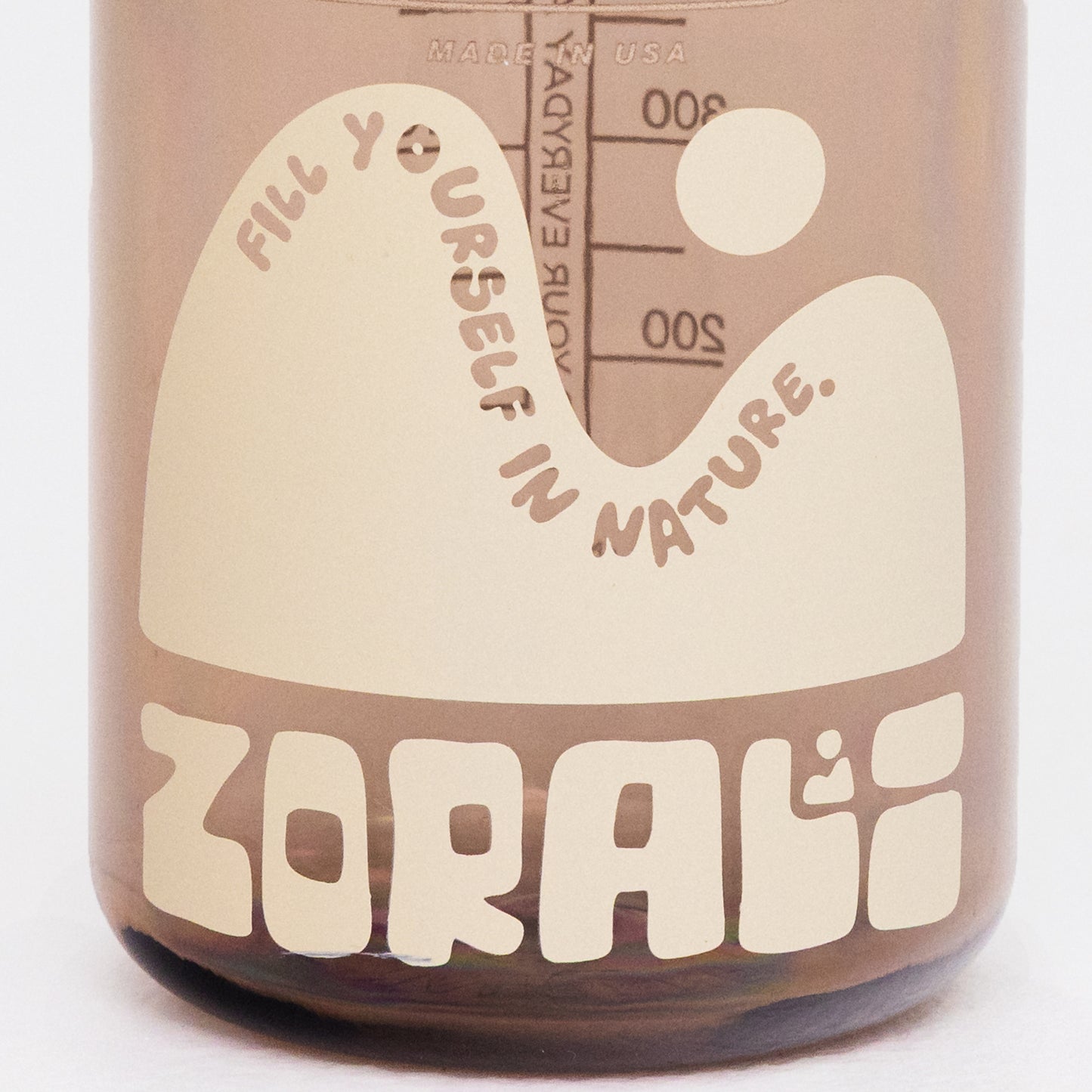 Bottle with 'Fill yourself in nature' text and ZORALI branding on a white background