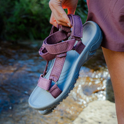Person wearing a sandal with a natural outdoor background