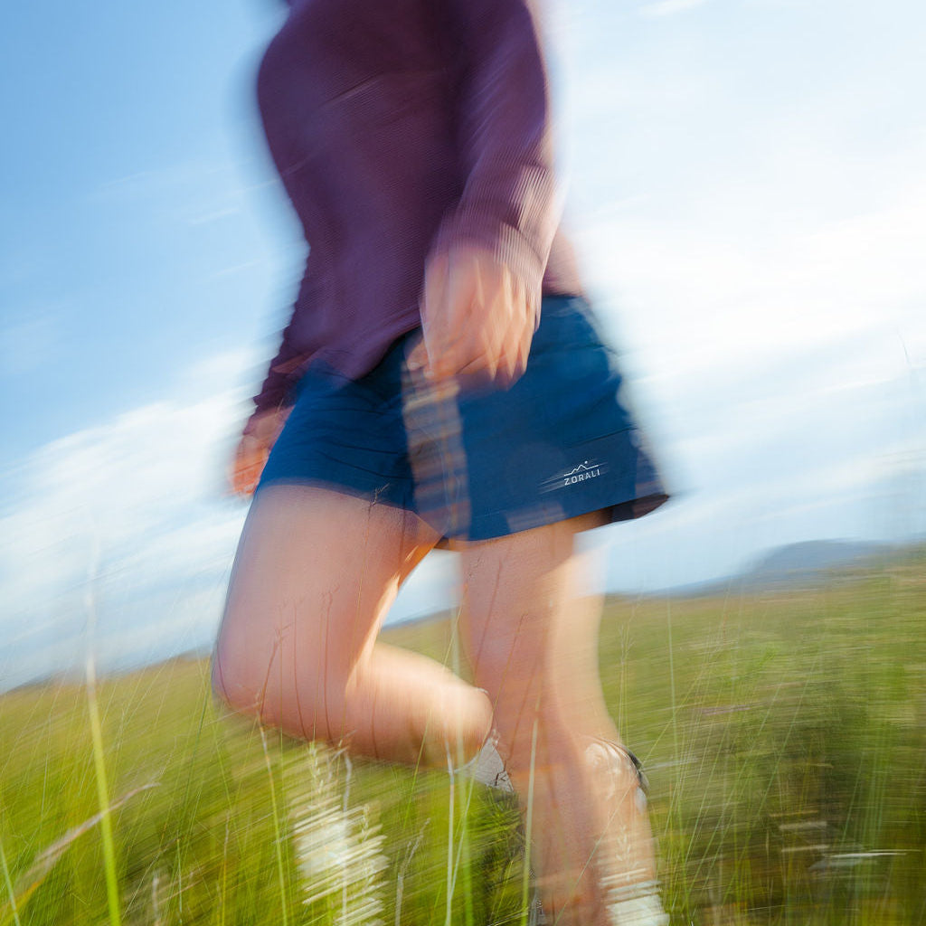 Person running in a field with a blurred effect