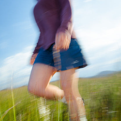 Person running in a field with a blurred effect
