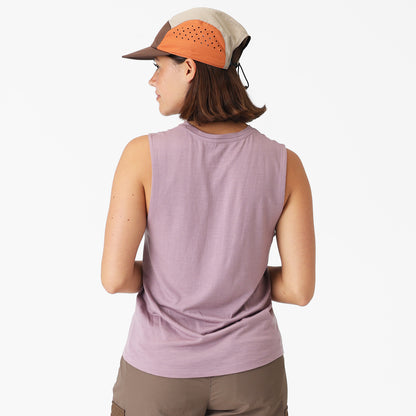 Person wearing a sleeveless purple top and a cap on a white background