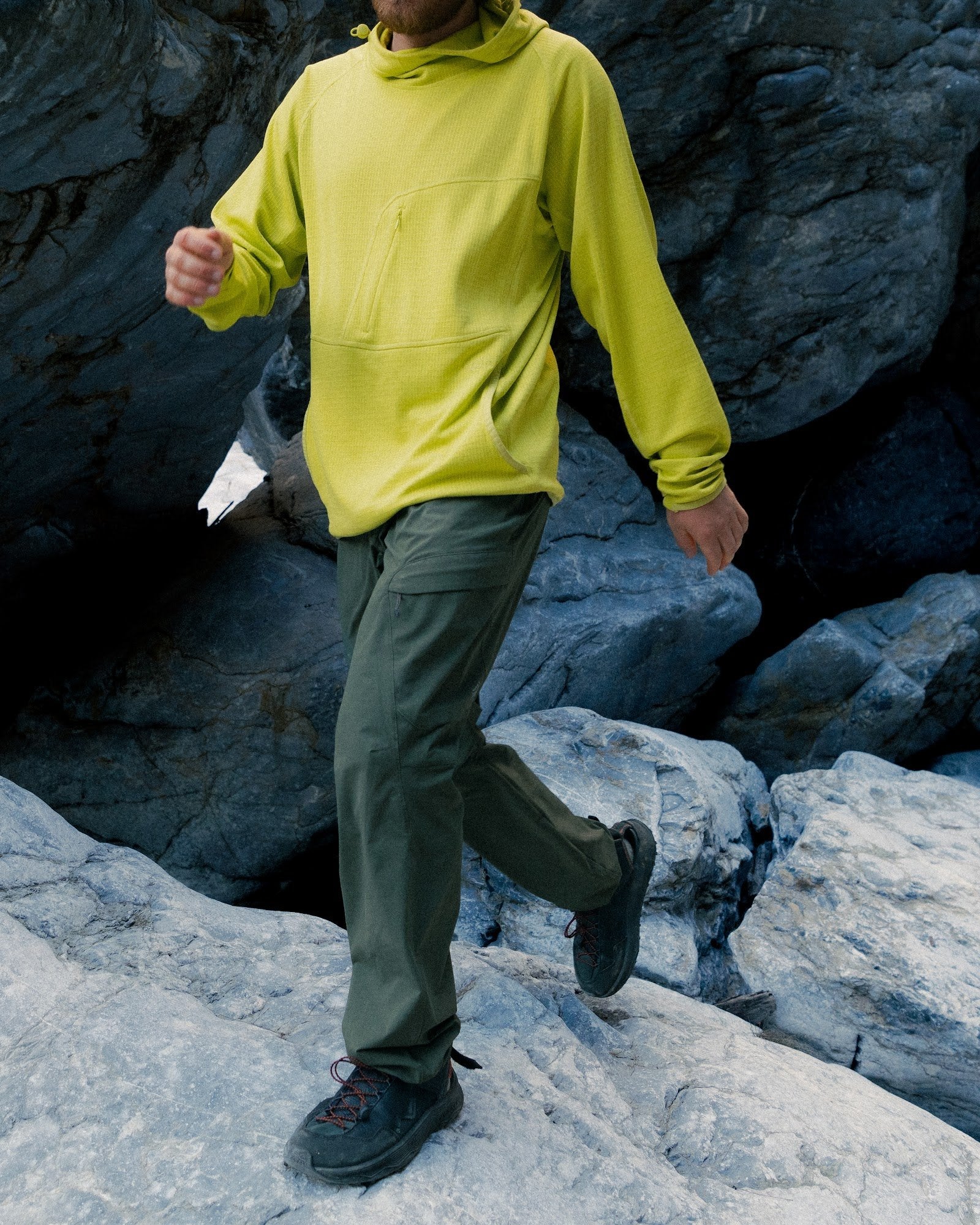 Mens Overland Pant in Forest Night, walking across granite