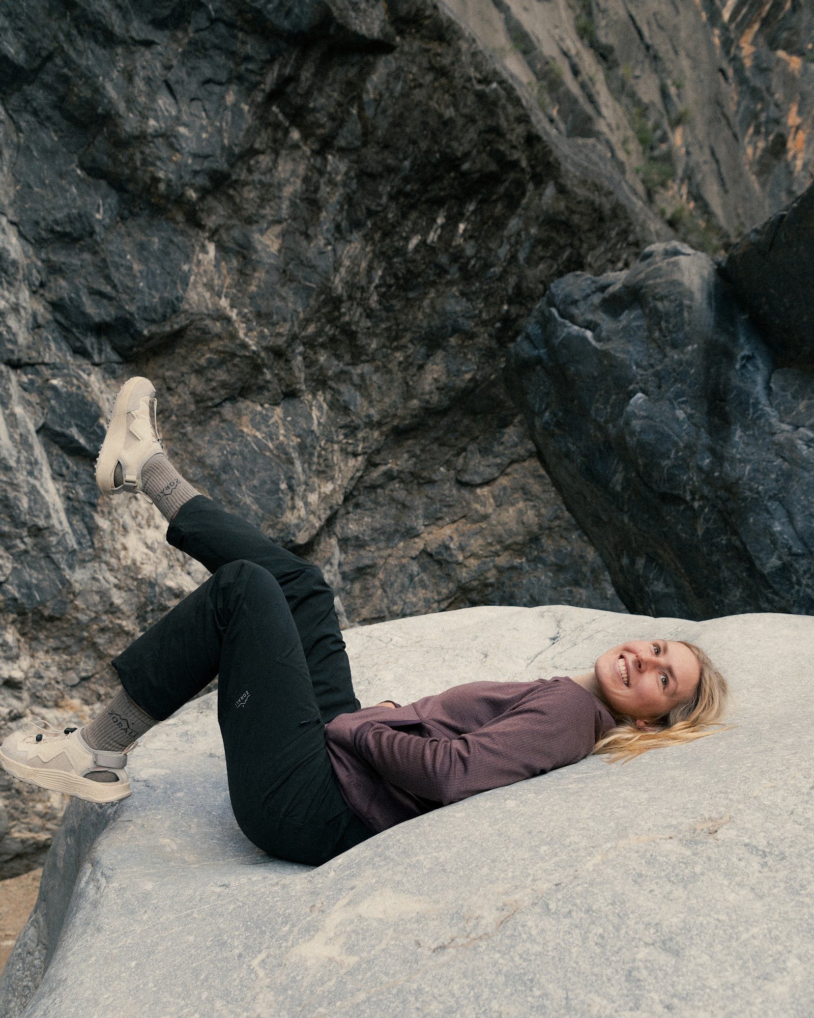 Womens Overland Pant in Black, resting on granite in the bush