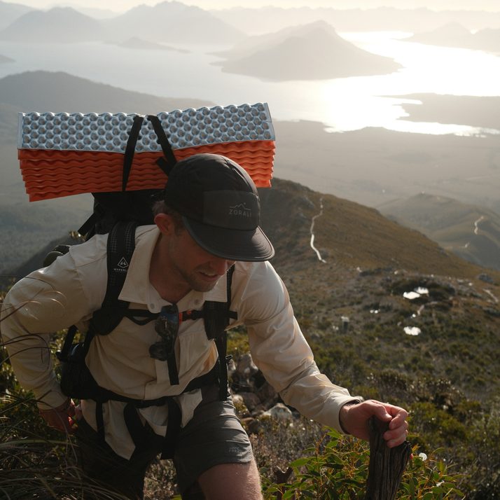 Cam climbing a ridge at golden hour in the Beachwood Daylight™ Technical Long Sleeve Shirt