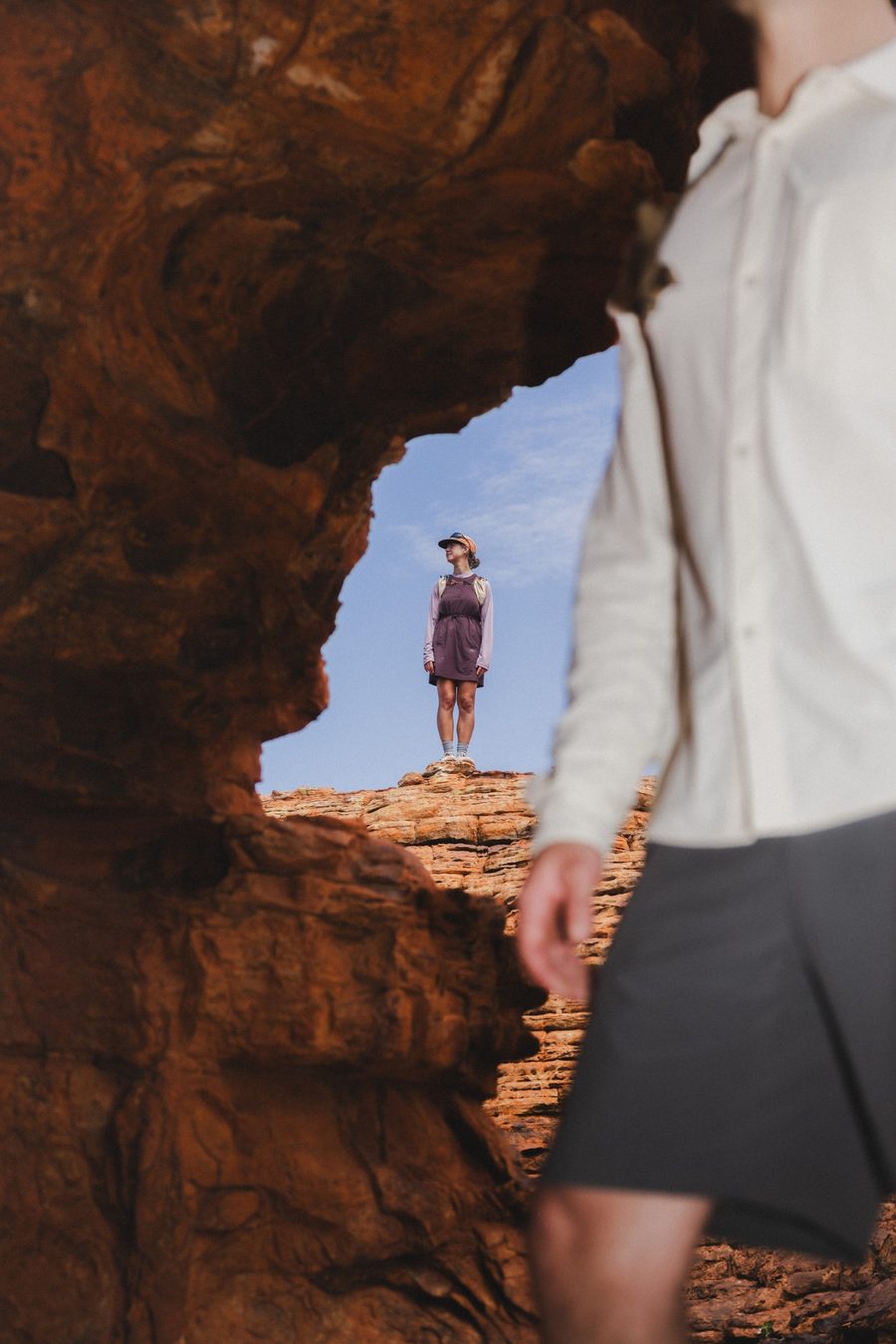 Daylight dress and shirt under a sandstone arch